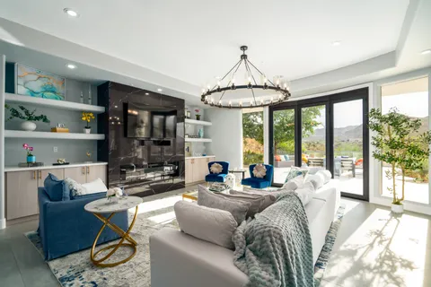 a living room with furniture a table and a chandelier