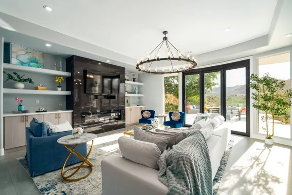 a living room with furniture a table and a chandelier
