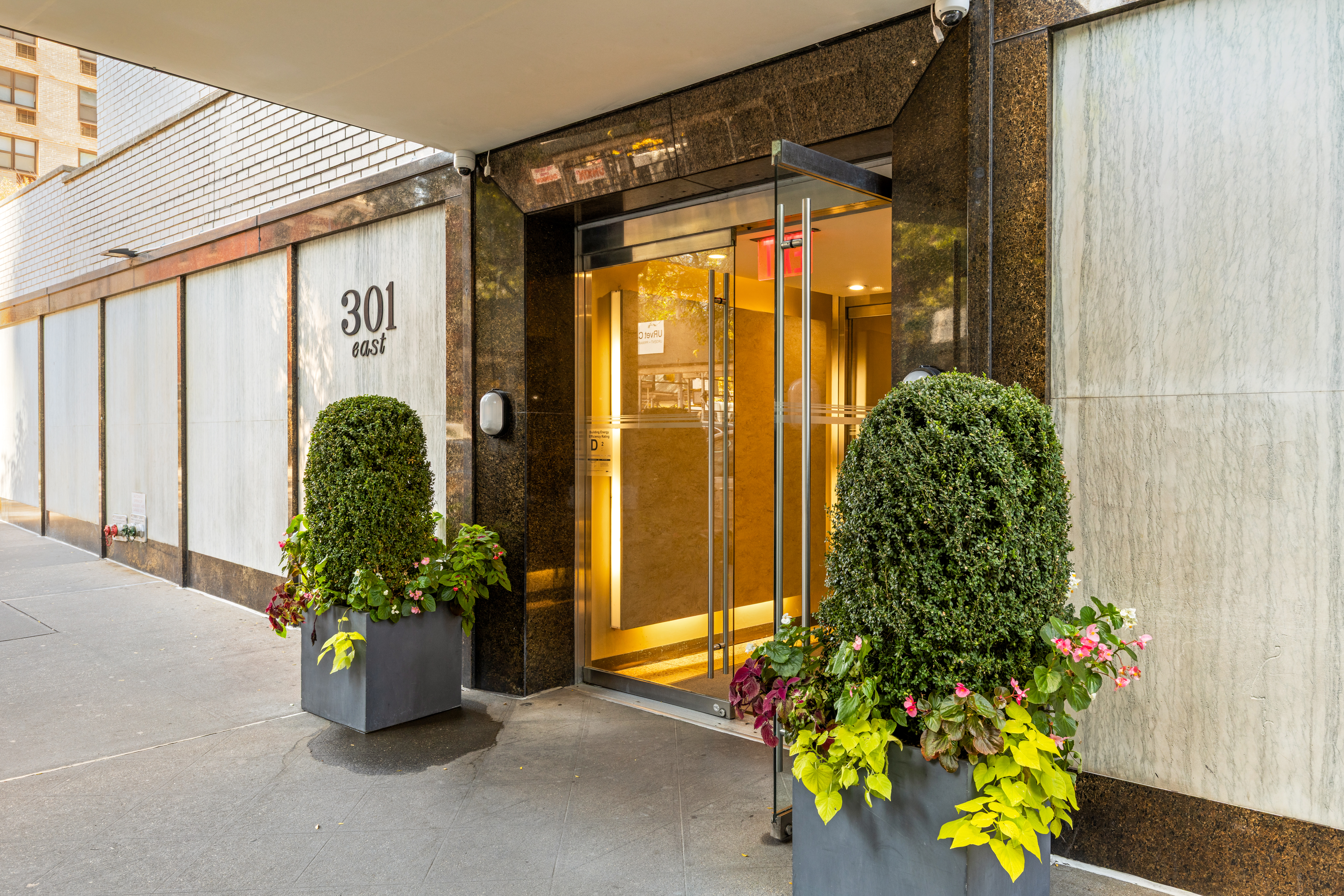 301 East 75th Street, Unit 14J Manhattan, NY 10021 - Photo 7 of 8 a front view of a house with a flower garden