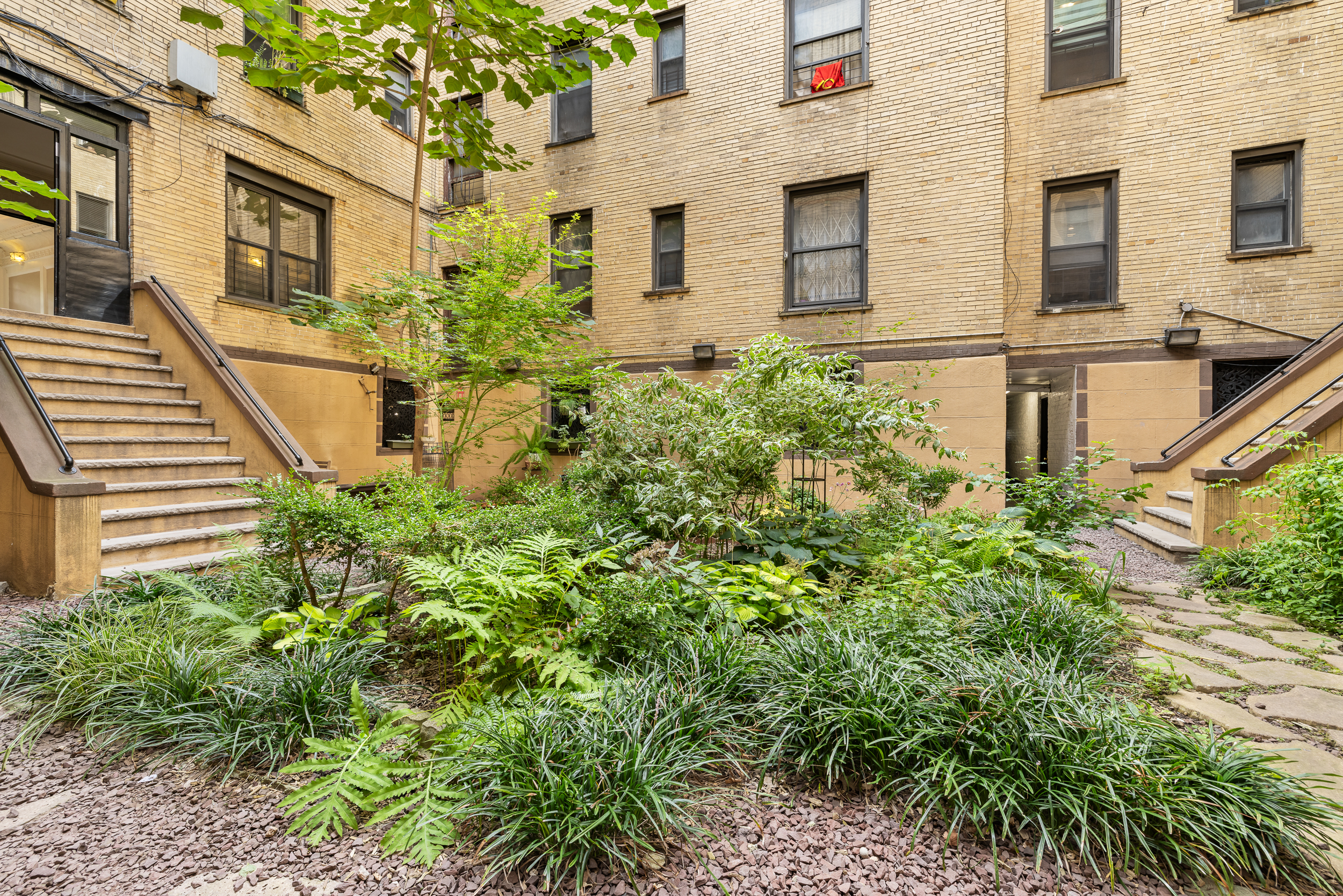 839 East 19th Street, Unit 4D Brooklyn, NY 11230 - Photo 8 of 10 a view of a brick house with windows and flower plants