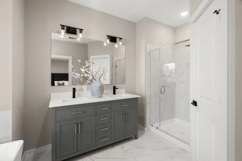 a bathroom with a double vanity sink mirror and shower