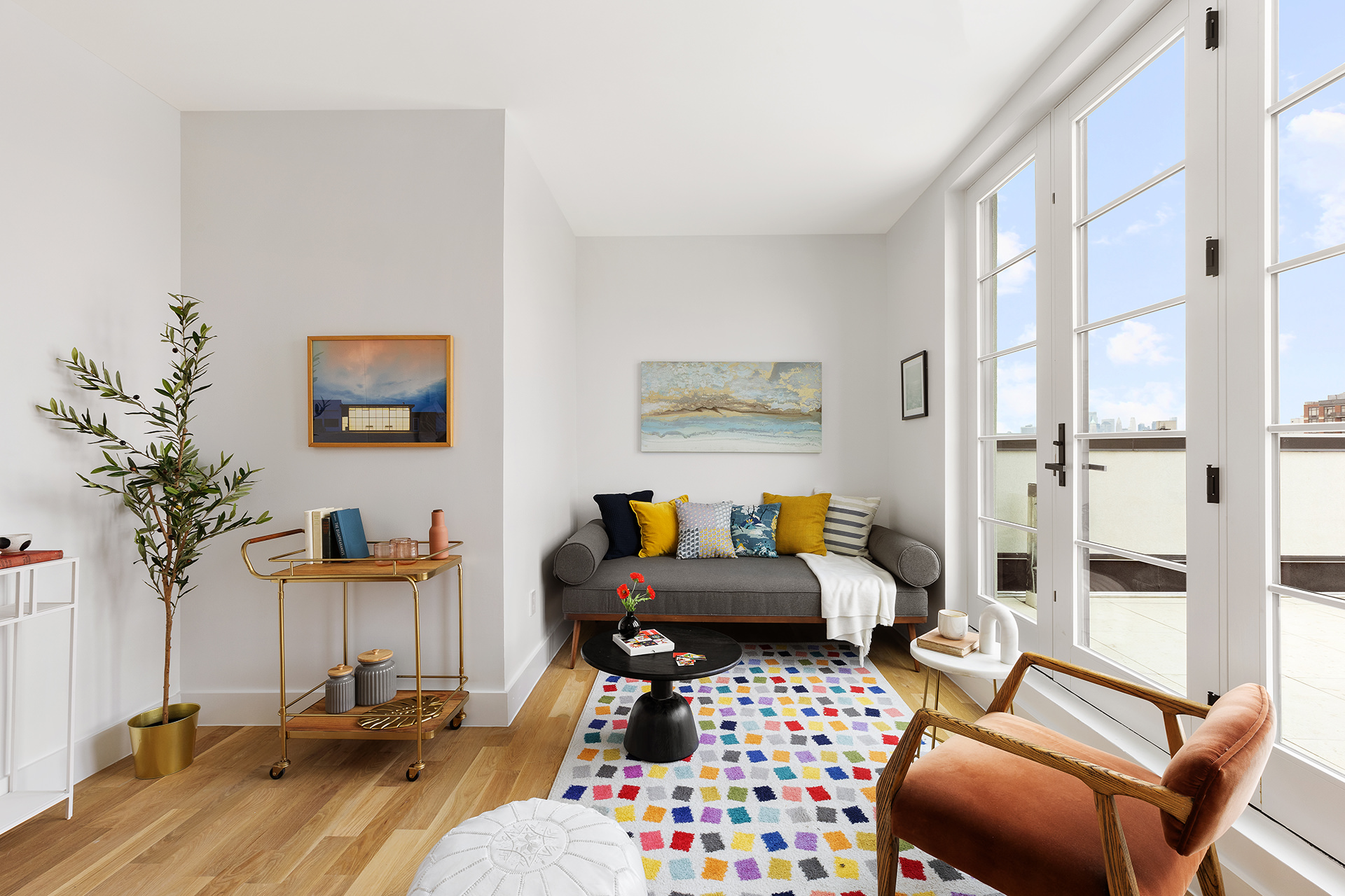 262 17th Street, Unit PH Brooklyn, NY 11215 - Photo 11 of 15 a living room with furniture a potted plant and a large window
