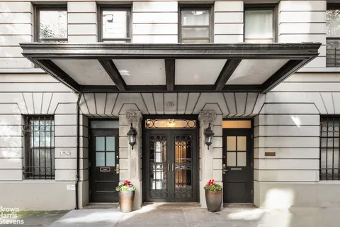a view of porch with a table and chairs