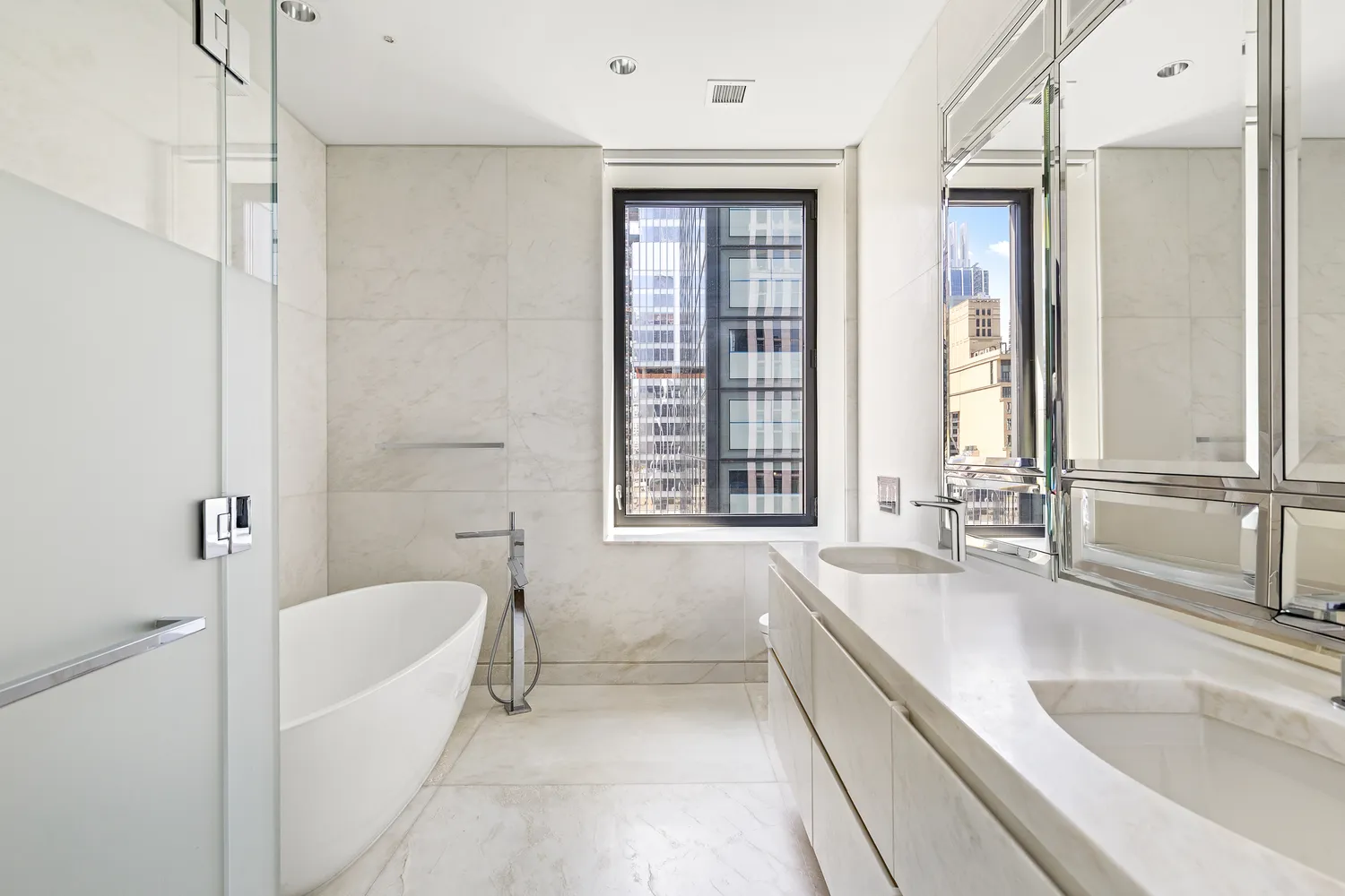a bathroom with a granite countertop tub sink and mirror
