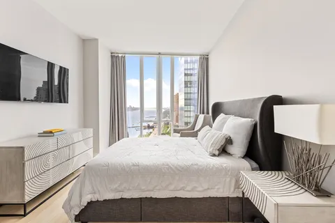 a bedroom with a bed and flat screen tv