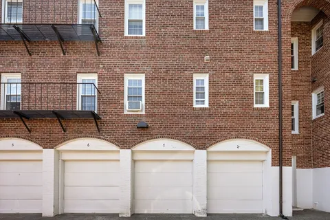 a couple of white and red brick building in front of a brick building