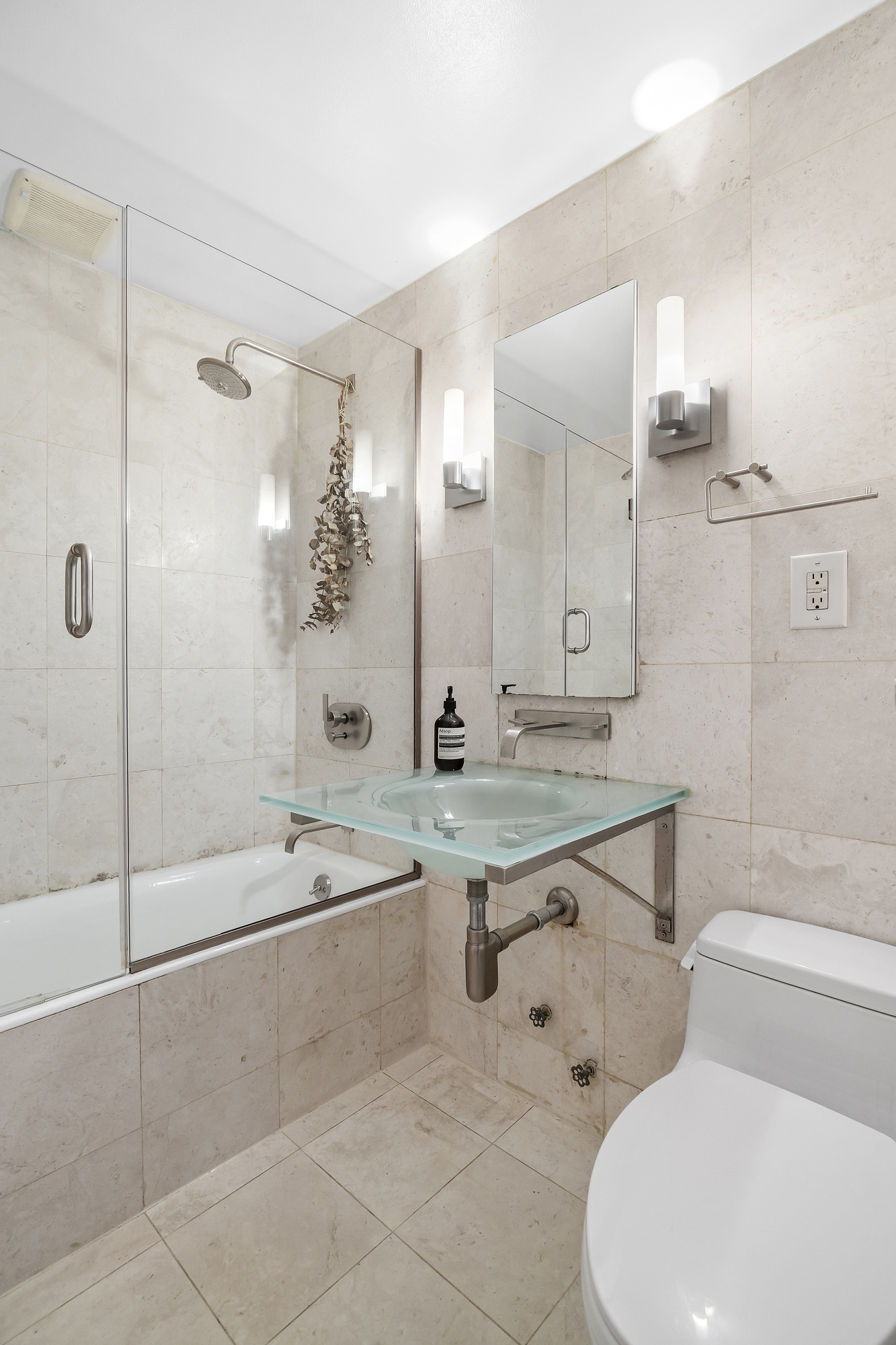 19 West 85th Street, Unit 3B Manhattan, NY 10024 - Photo 11 of 12 a bathroom with a sink a toilet and shower