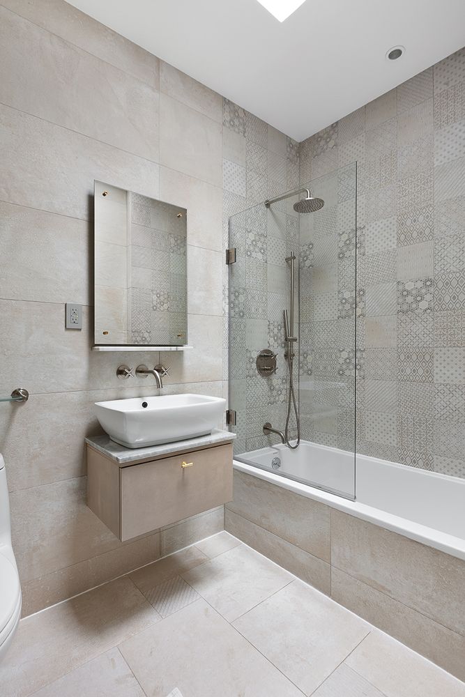 512 Lorimer Street Brooklyn, NY 11211 - Photo 13 of 22 a spacious bathroom with a tub sink shower and mirror