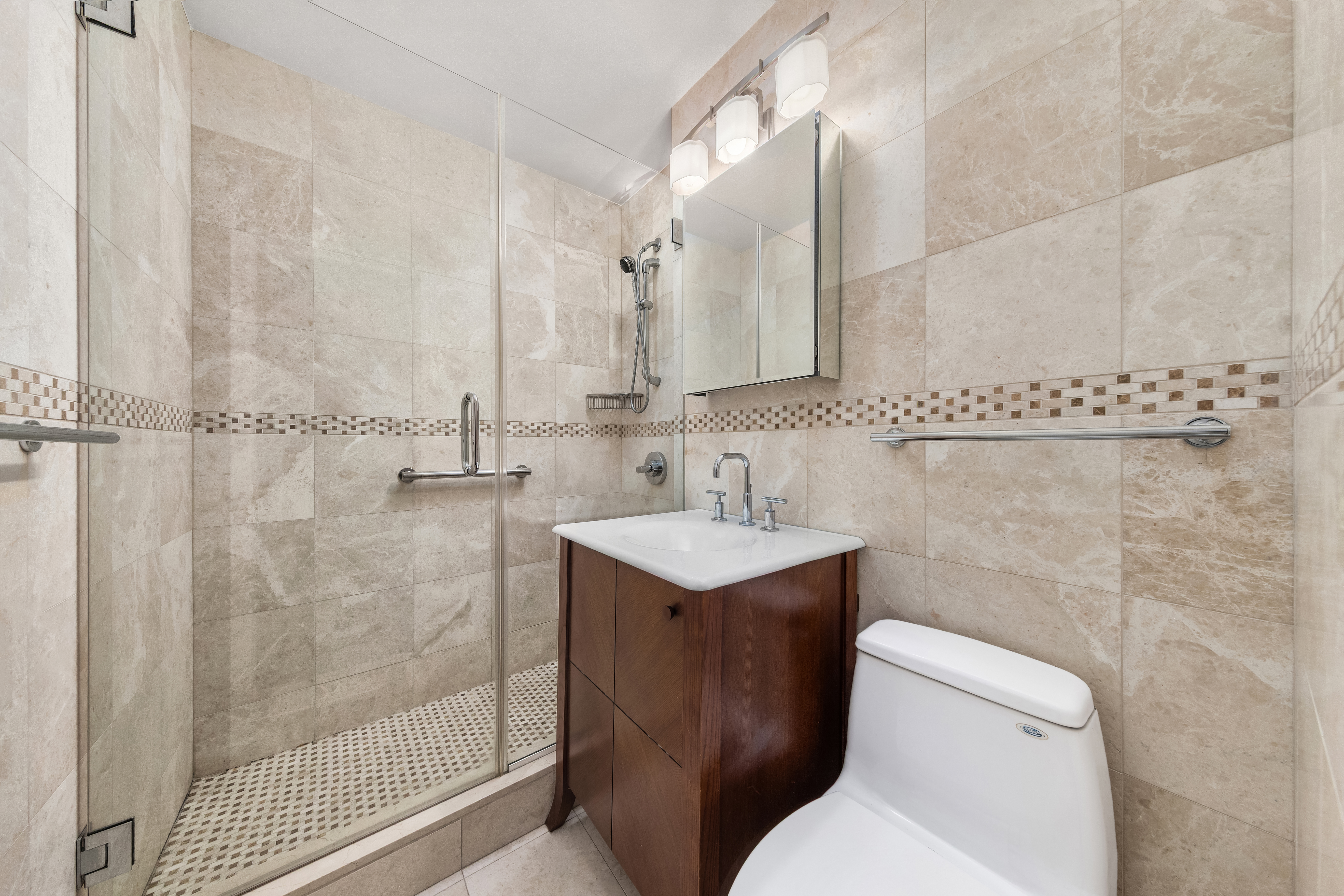 77 West 55th Street, Unit 17F Manhattan, NY 10019 - Photo 4 of 12 a bathroom with a sink toilet and shower