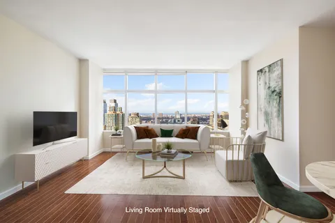 a living room with furniture wooden floor and a flat screen tv