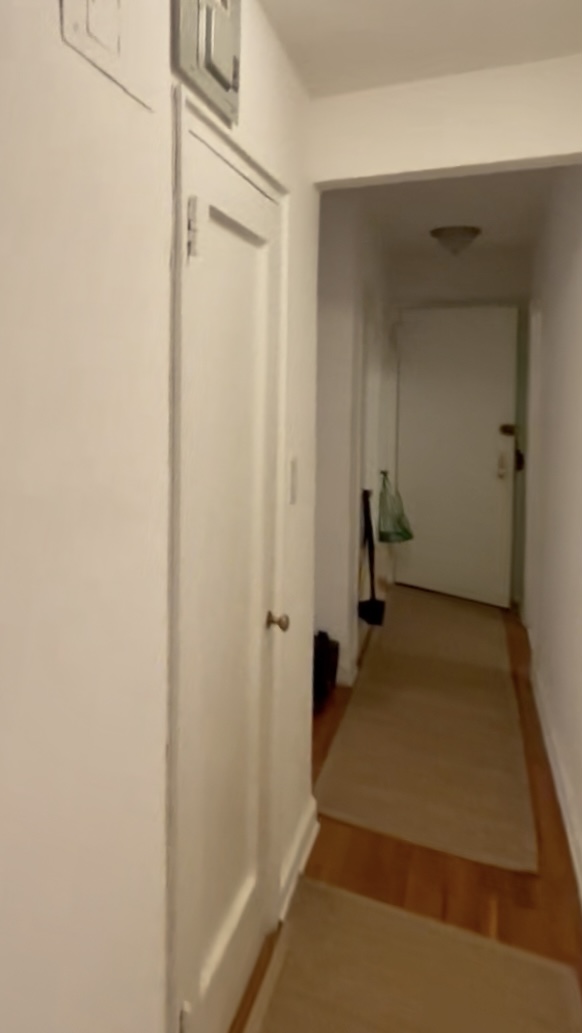 330 East 58th Street, Unit 4A Manhattan, NY 10022 - Photo 9 of 11 a view of a hallway with wooden floor and staircase