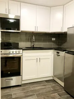 a stove top oven sitting inside of a kitchen