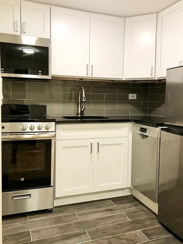 80 Park Avenue, Unit 12F Manhattan, NY 10016 - Photo 4 of 10 a stove top oven sitting inside of a kitchen