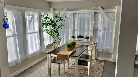 a view of a room with furniture and a window