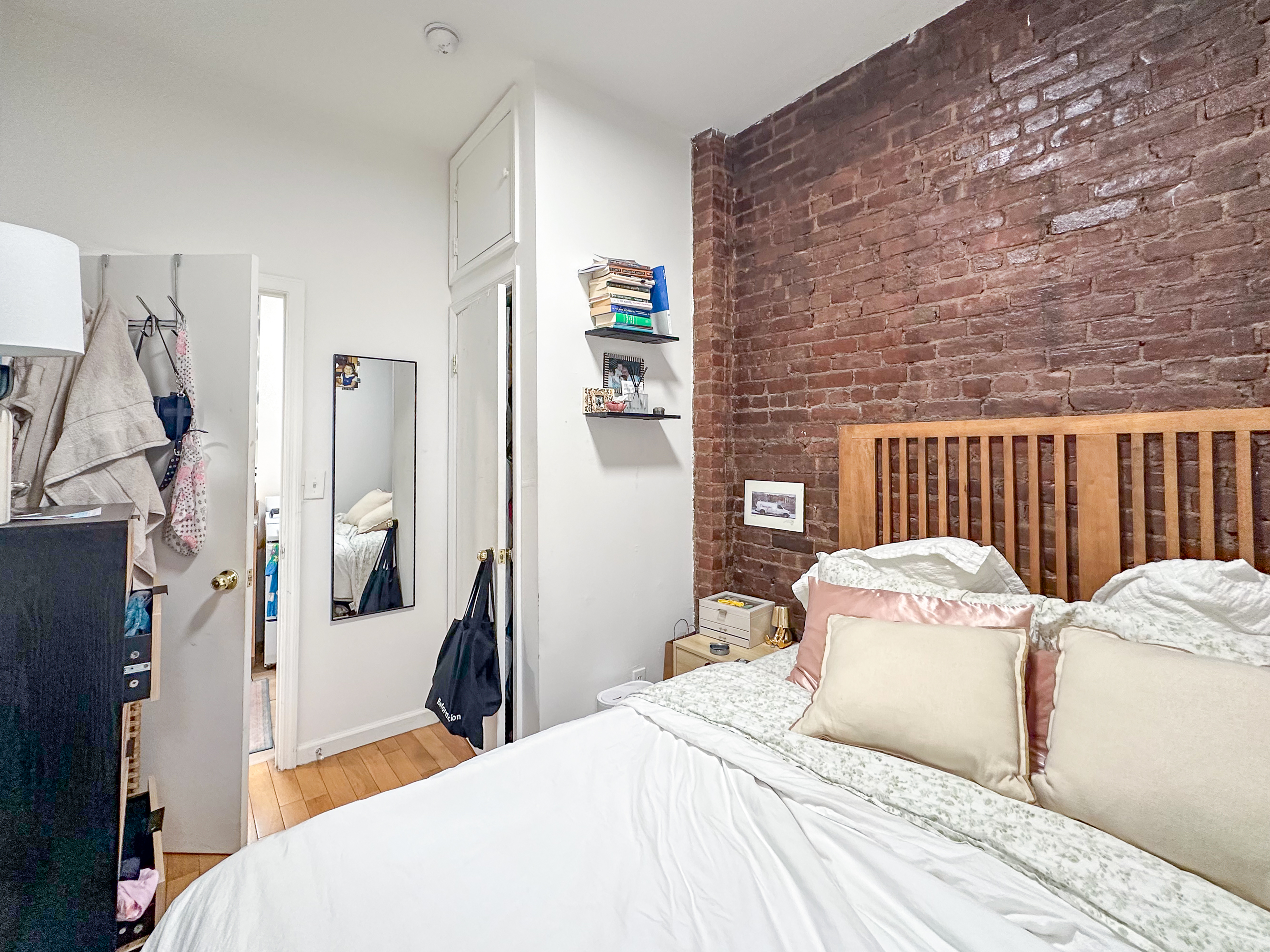 51 East 2nd Street, Unit 10 Manhattan, NY 10003 - Photo 6 of 16 a bedroom with a bed and a chandelier