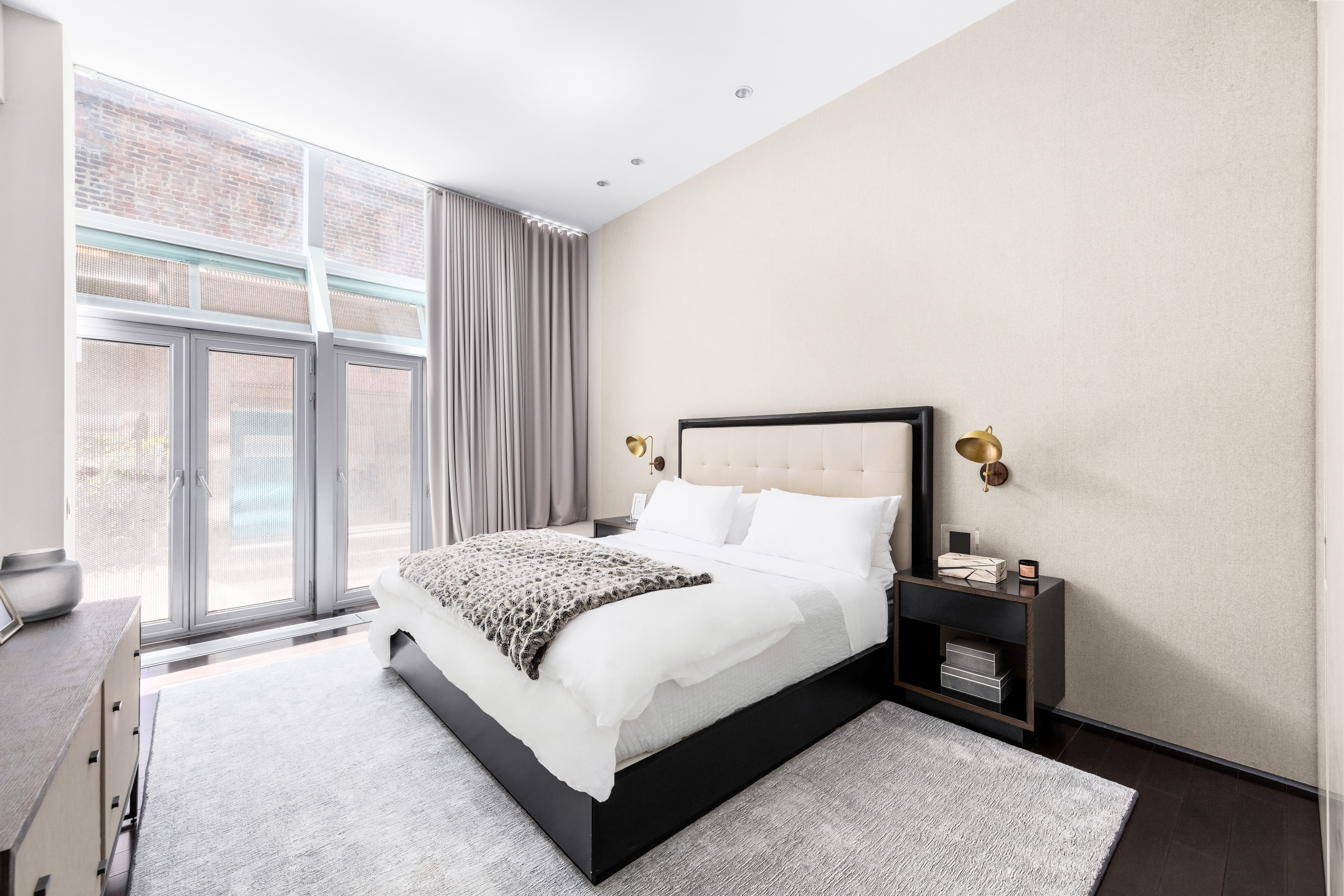 166 Perry Street, Unit 1B Manhattan, NY 10014 - Photo 4 of 17 a large bed sitting in a bedroom next to a window