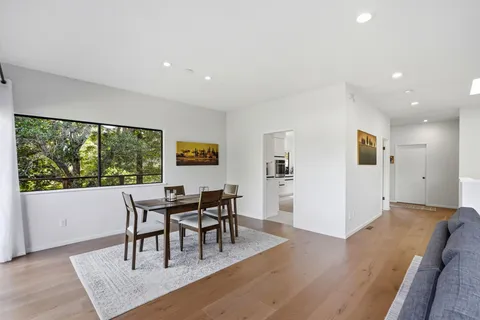 a dining room with furniture and wooden floor
