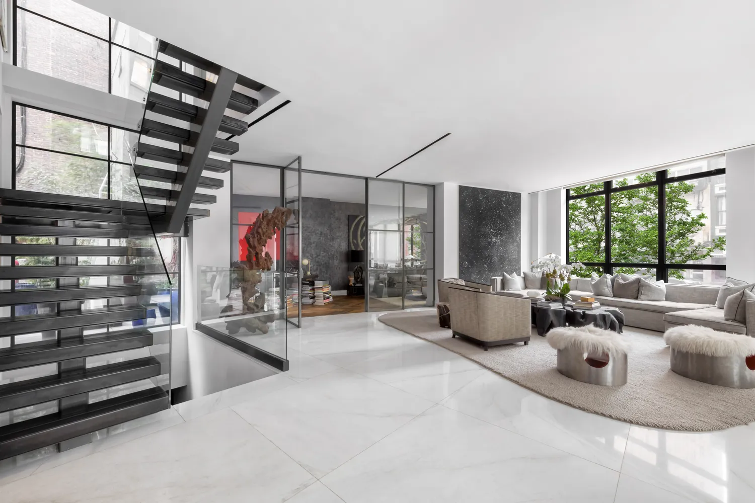 a living room with lots of furniture and a large window