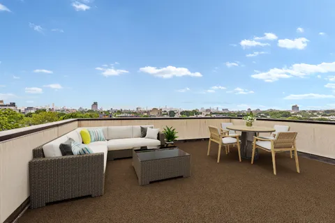 a view of a terrace with couches and lounge chairs