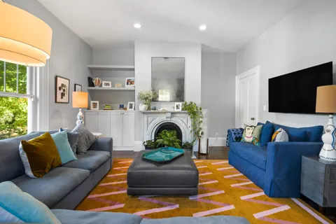 a living room with furniture and a fireplace