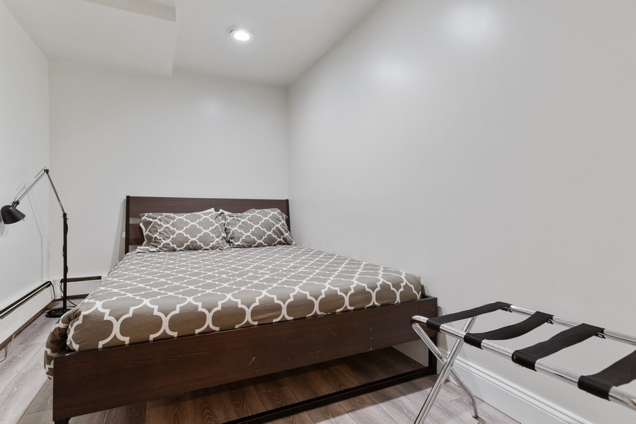 673 Metropolitan Avenue, Unit B Brooklyn, NY 11211 - Photo 7 of 7 a bedroom with a bed and a mirror