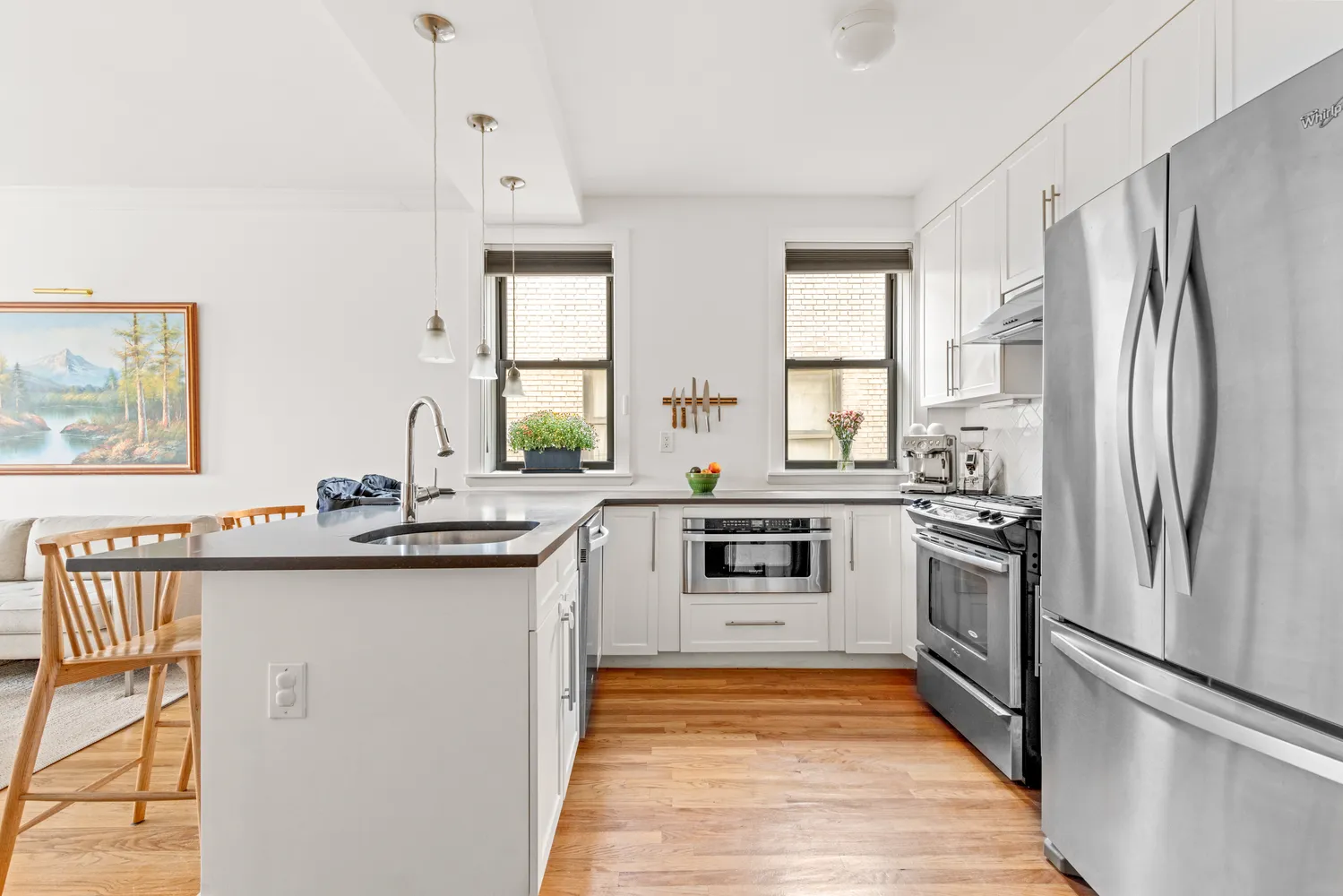 a kitchen with stainless steel appliances granite countertop a sink stove and refrigerator