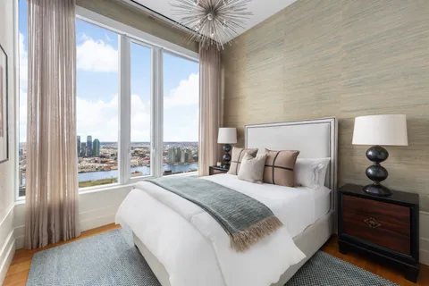 a bedroom with a large bed and a window