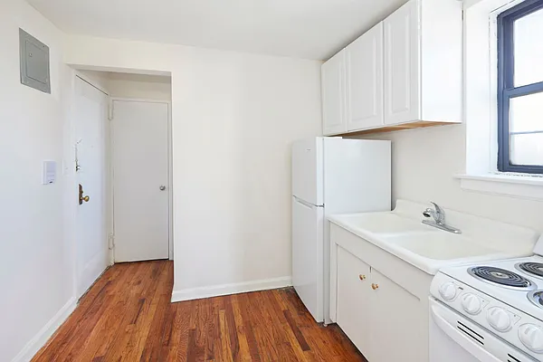 506 West 145th Street, Unit 4D Manhattan, NY 10031 - Photo 4 of 9 a room with a sink and dishwasher with wooden floor