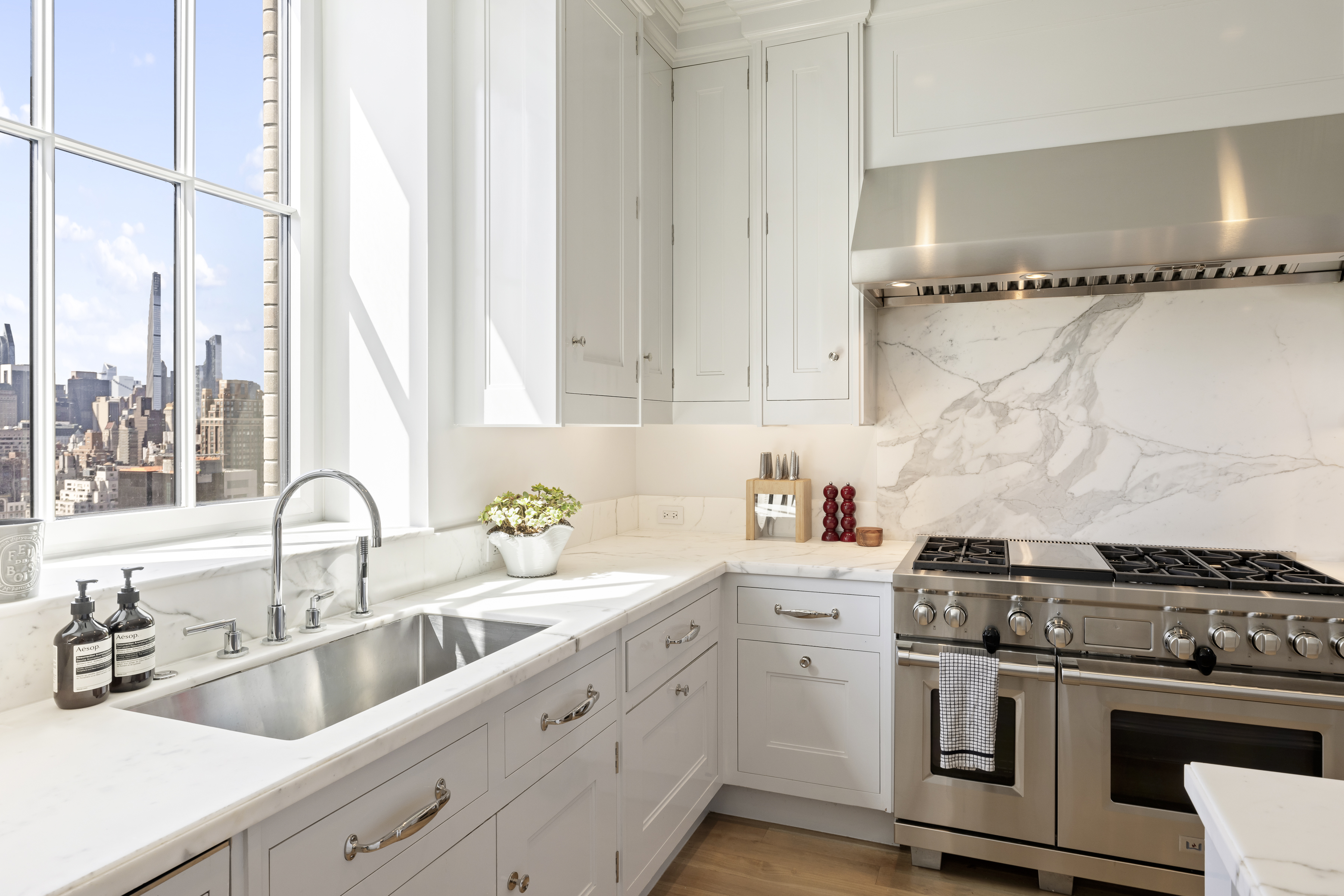301 East 80th Street, Unit 25B Manhattan, NY 10075 - Photo 11 of 38 a kitchen with stainless steel appliances granite countertop a sink stove and refrigerator