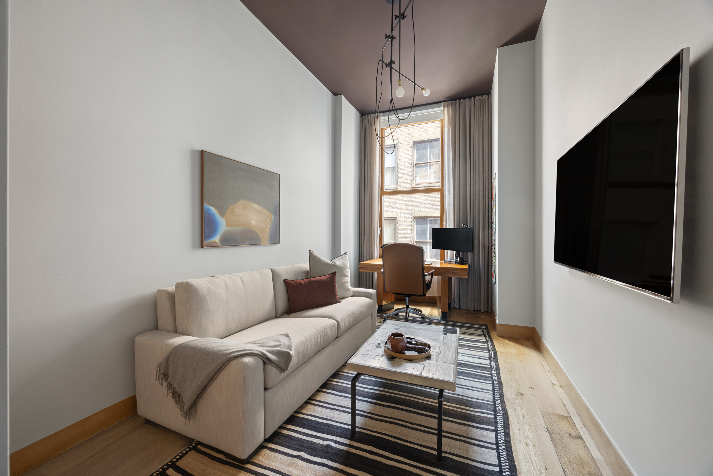 60 White Street, Unit 4E Manhattan, NY 10013 - Photo 15 of 19 a living room with furniture a flat screen tv and a window