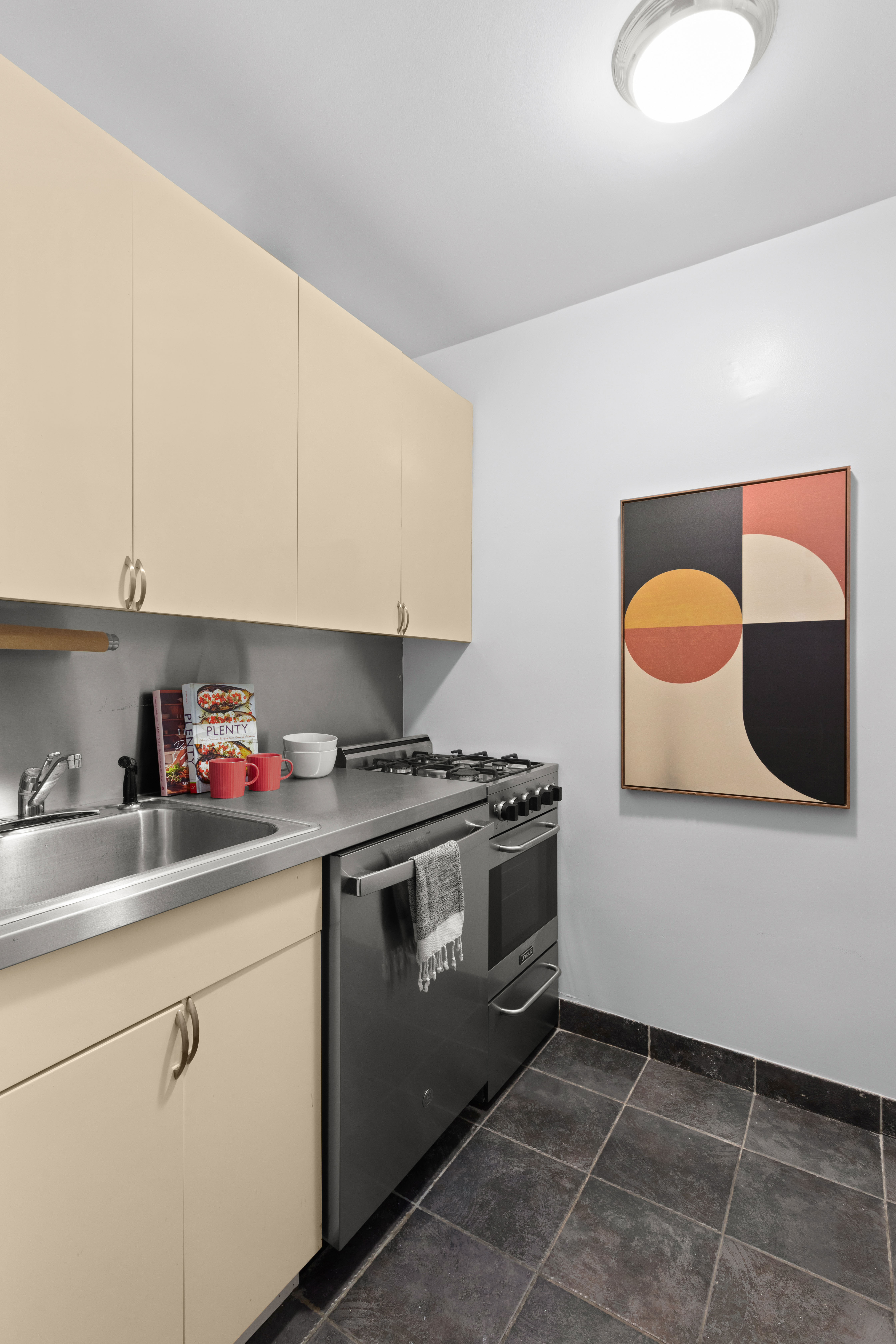 200 West 20th Street, Unit 1002 Manhattan, NY 10011 - Photo 4 of 8 a kitchen with stainless steel appliances granite countertop a sink and a stove