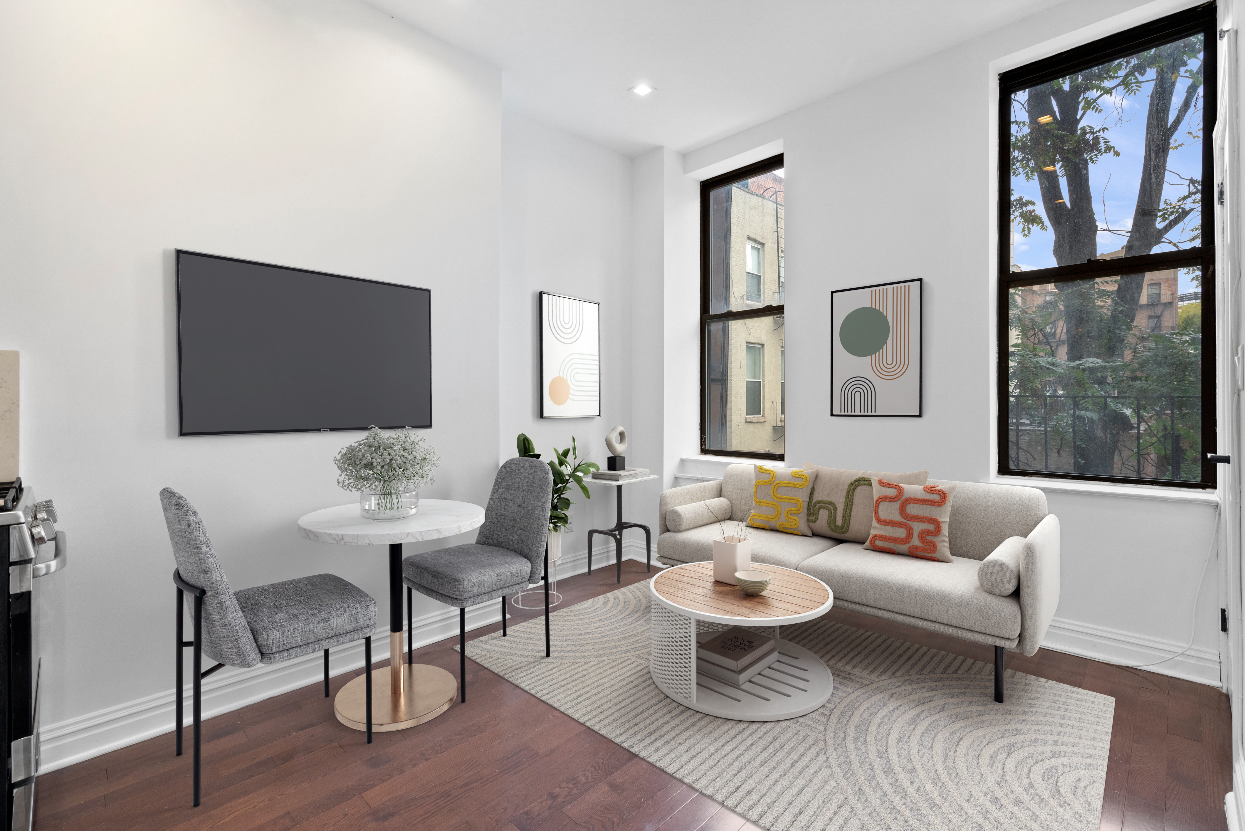 31 St Marks Place, Unit 10 Manhattan, NY 10003 - Photo 1 of 8 a living room with furniture a rug and a window