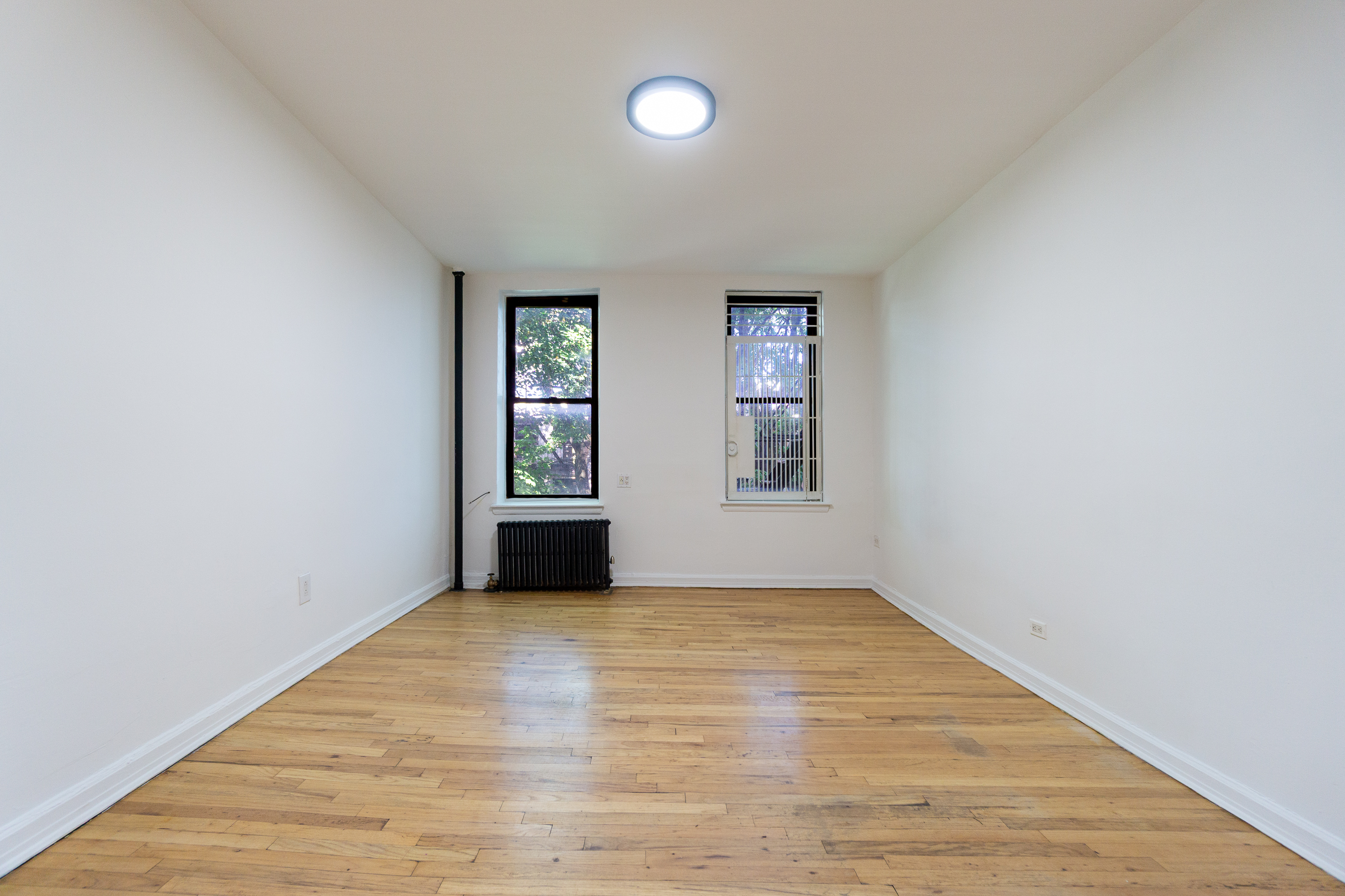 319 East 5th Street, Unit 13 Manhattan, NY 10003 - Photo 2 of 13 an empty room with windows