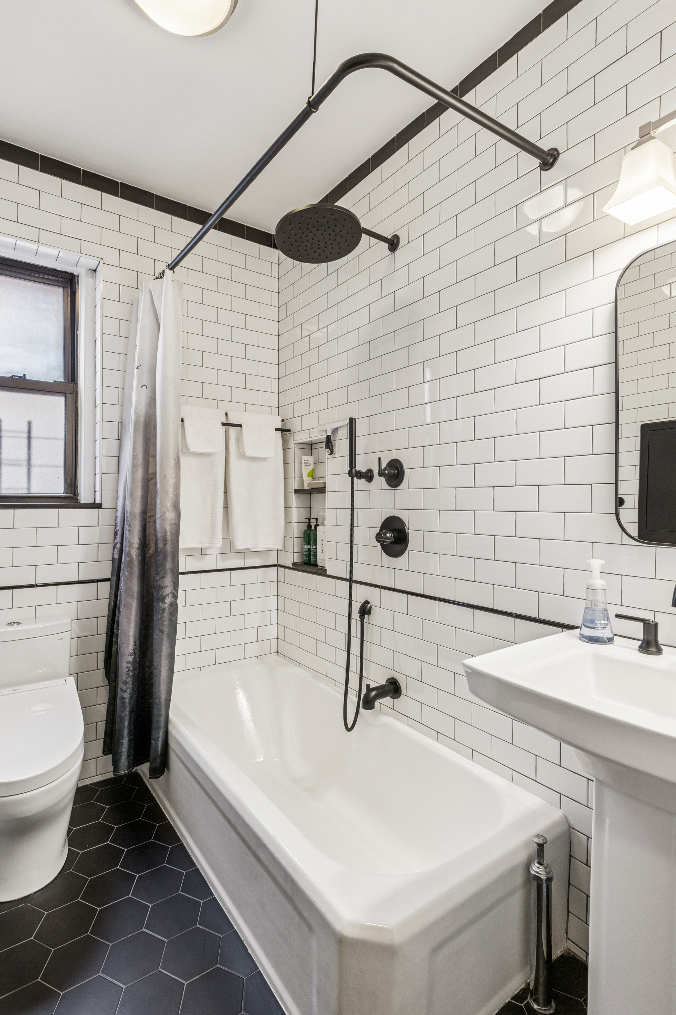 60 Cooper Street, Unit 5J Manhattan, NY 10034 - Photo 7 of 17 a bathroom with a sink a toilet and shower