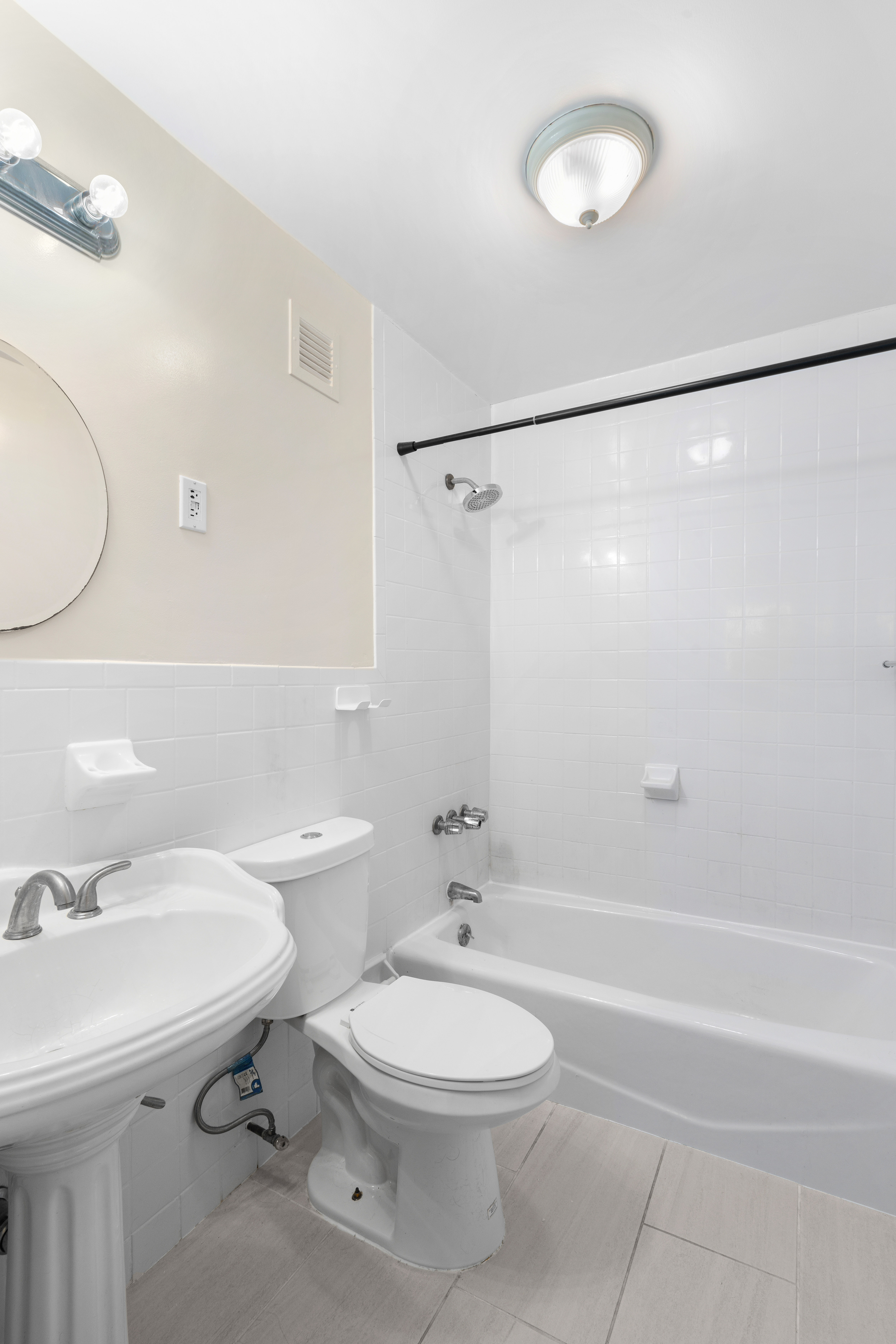 236 West 52nd Street, Unit B1 Manhattan, NY 10019 - Photo 5 of 15 a bathroom with a toilet sink and shower