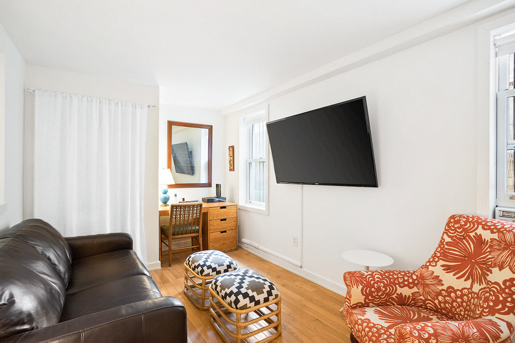 315 Washington Avenue Brooklyn, NY 11205 - Photo 37 of 38 a living room with furniture and a flat screen tv