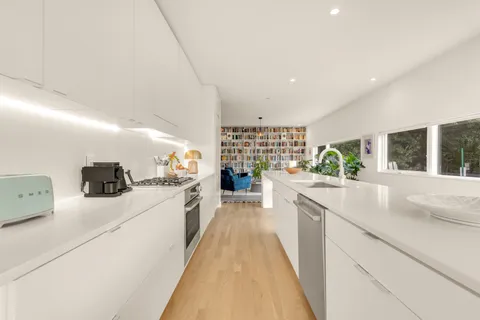 a kitchen with counter top space and windows