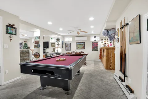 a living room with furniture and painting on the wall