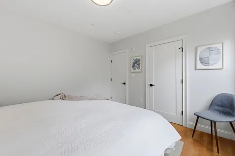 a bedroom with a bed and a chair