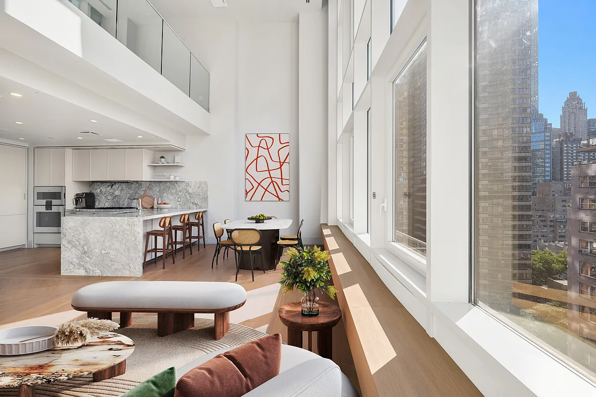 1059 3rd Avenue, Unit 10C Manhattan, NY 10065 - Photo 1 of 7 a living room with furniture and a large window