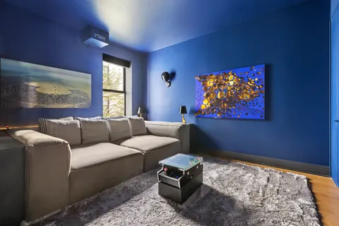 a living room with furniture a couch and a flat screen tv