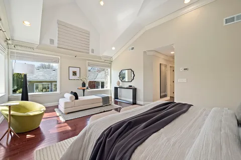 a spacious bedroom with a bed and a view of bedroom