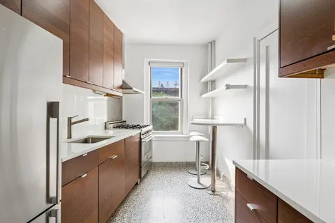 a kitchen with a sink stove and refrigerator
