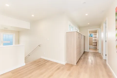 a view of hallway with stairs and a window