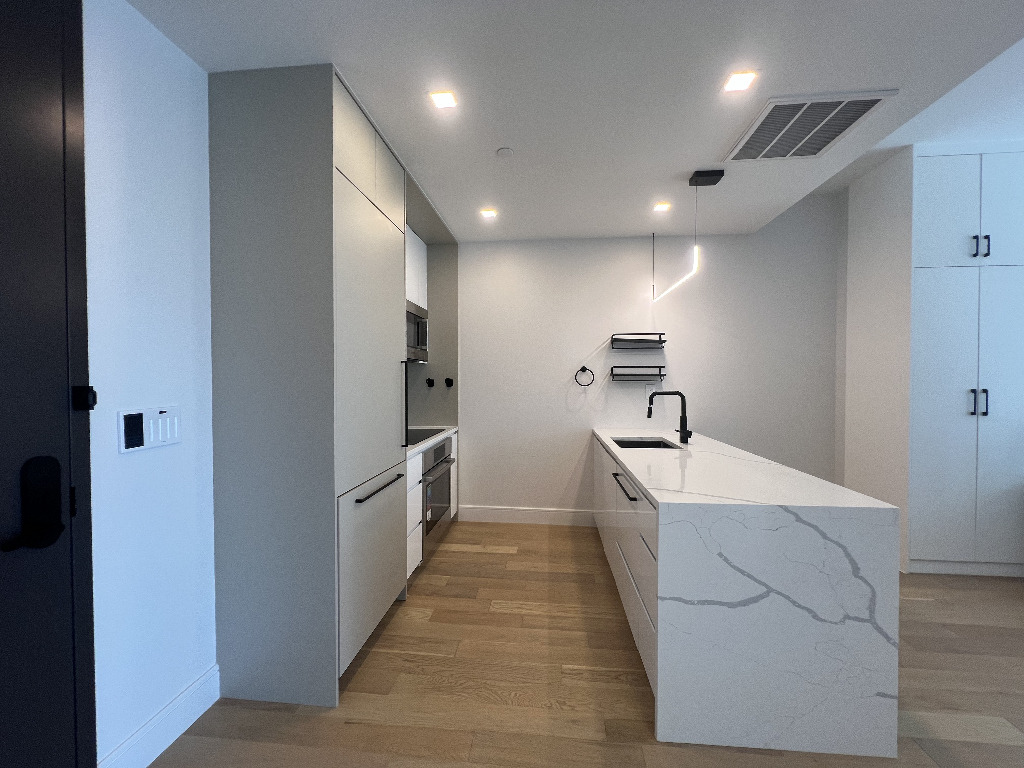 37-34 33rd Street, Unit 7H Queens, NY 11101 - Photo 4 of 18 a large kitchen with a sink and refrigerator
