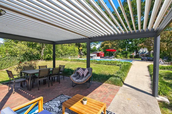 a view of a patio with lawn chairs next to a yard