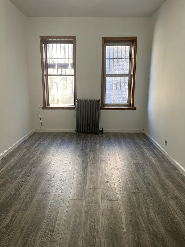 571 Nostrand Avenue, Unit 3R Brooklyn, NY 11216 - Photo 3 of 7 an empty room with wooden floor and windows