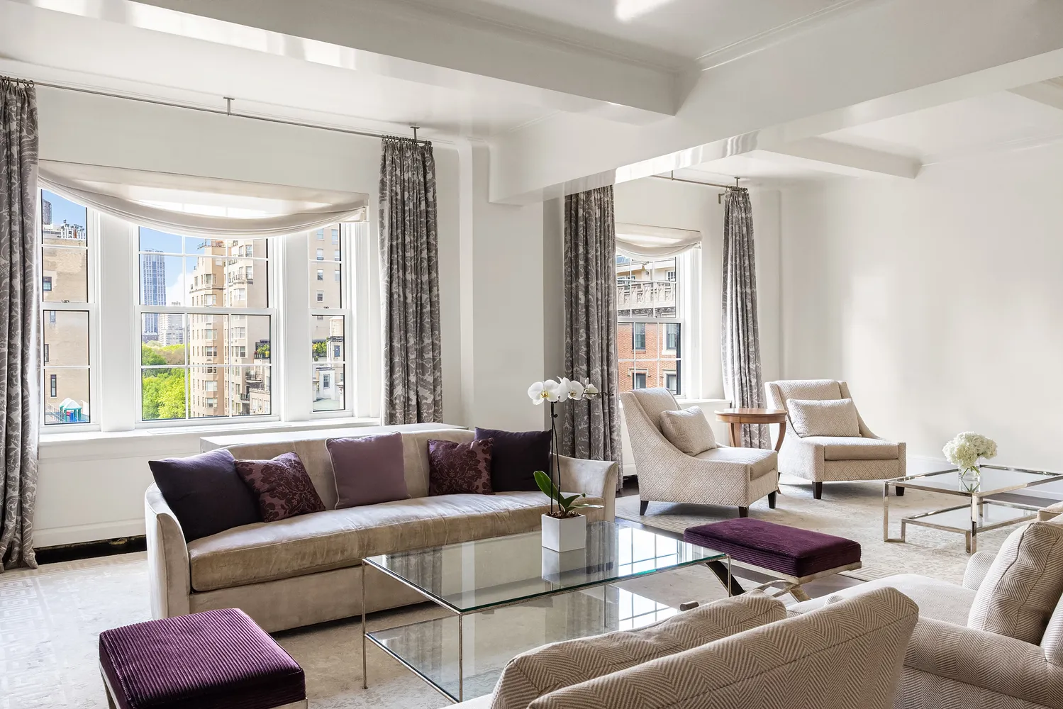 a living room with furniture and large windows