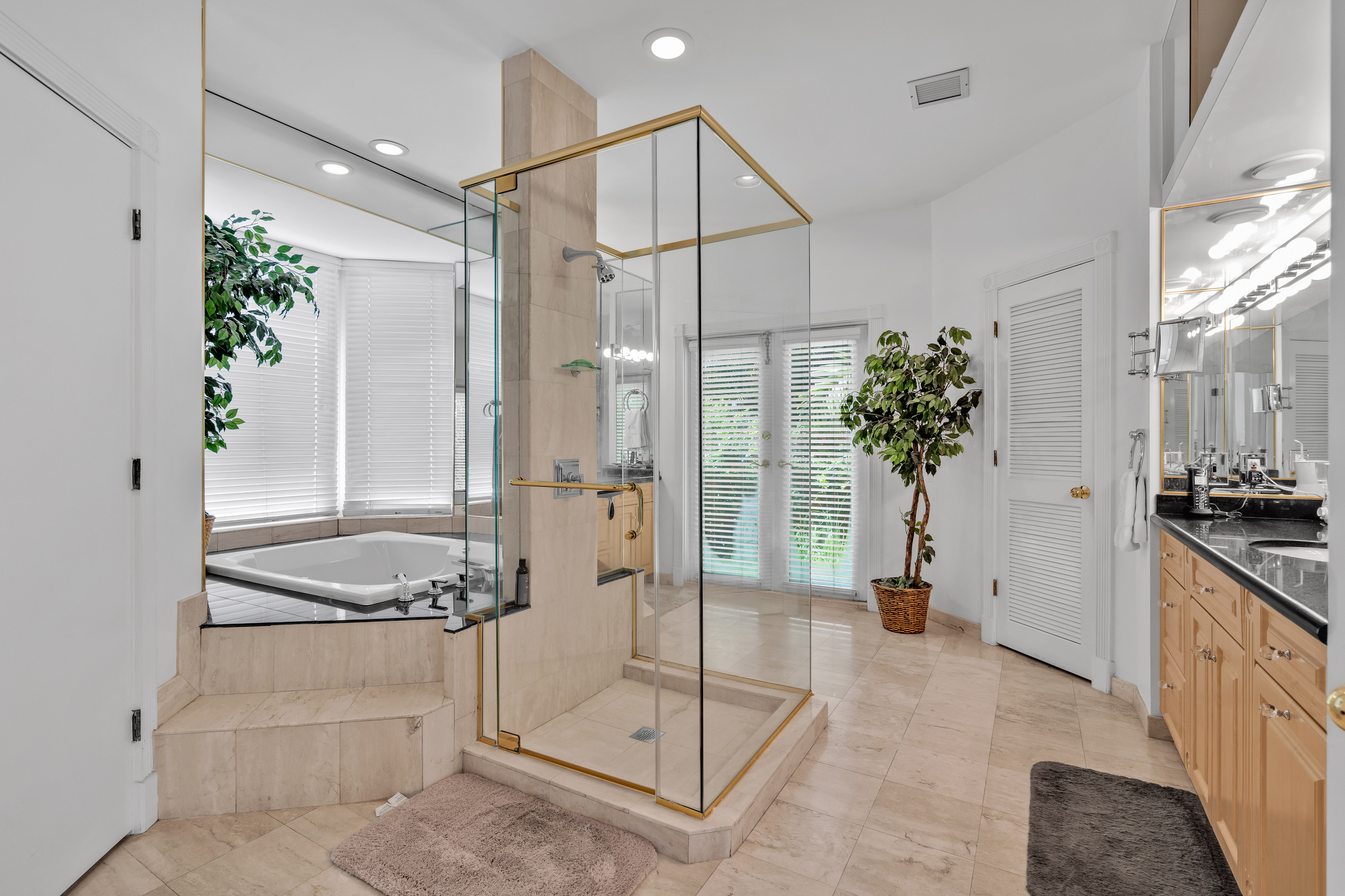 8768 Southwest 62nd Court Miami, FL 33156 - Photo 46 of 56 a spacious bathroom with a granite countertop shower a sink and mirror