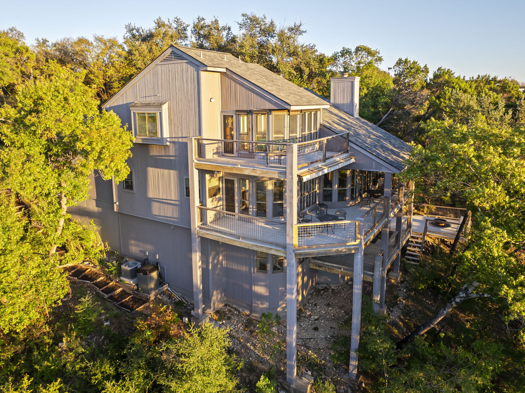 1605 The High Road Austin, TX 78746 - Photo 37 of 45 a view of a house with brick walls and flower plants